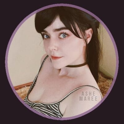 Portrait of a young woman with dark hair, blue eyes, wearing a striped top and black choker, framed by a purple circular border.