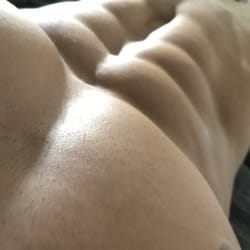 Close-up of a person's bare back, highlighting skin texture and gentle folds.